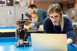 Young woman engineer working on robotics project